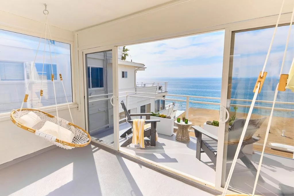 Oceanfront King Room with private balcony boasting stunning Pacific views. Indulge in ultimate comfort on a king-size Avocado Green Mattress floating bed. The en-suite bathroom features a walk-in shower and vanity.