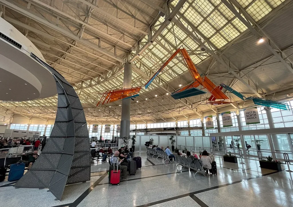 Interior view of Houston Hobby Airport showing compact terminal design and Texas-themed retail stores