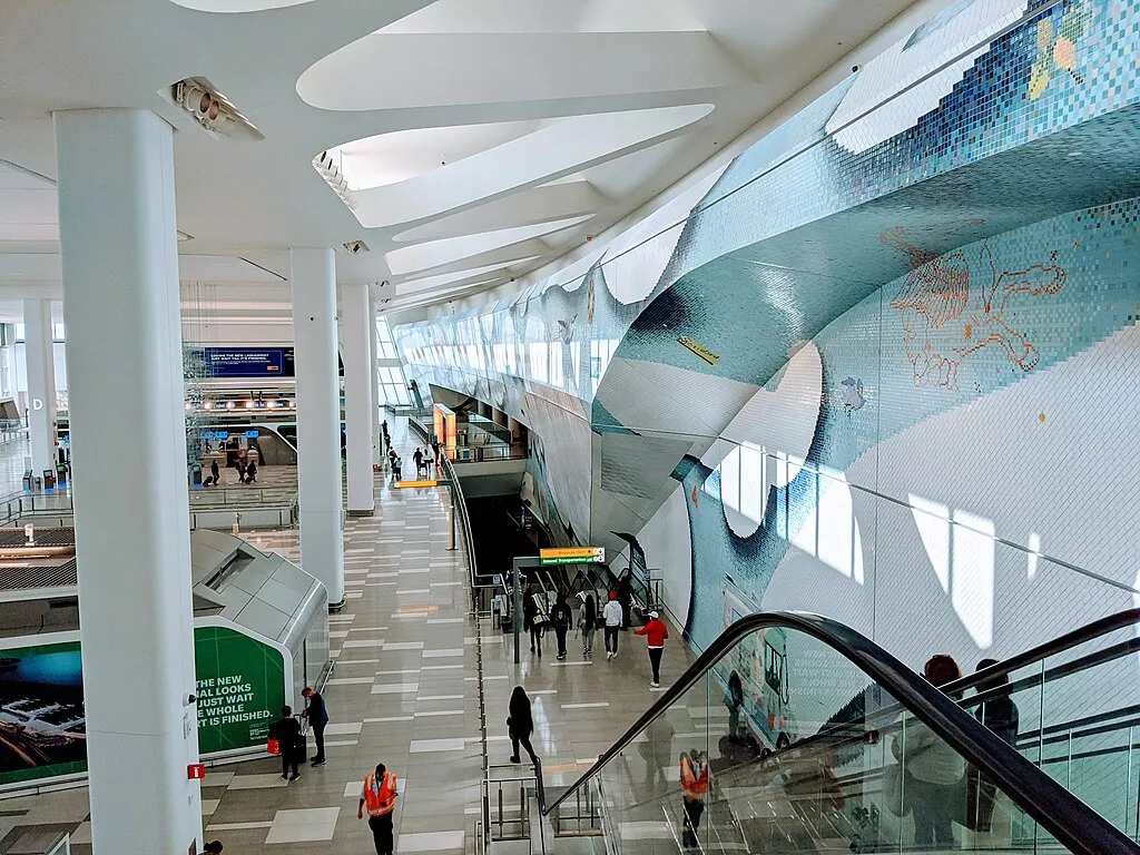 Interior of LaGuardia Airport Terminal B in New York City featuring glass walls and natural light after major renovation